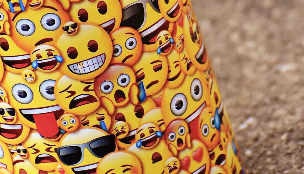 Street pole wrapped in emoji face paper