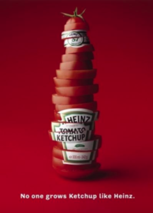 Ad showing tomato slices stacked in the shape of a ketchup bottle, with a Heinz logo. Slogan: No one grows ketchup like Heinz.